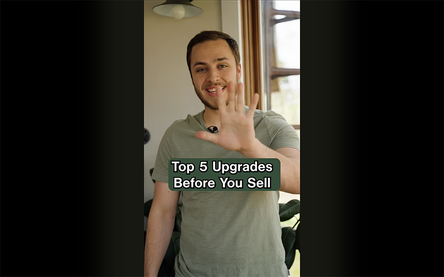 Tyler from FreshDoor Real Estate holding up 5 fingers to represent the top 5 home upgrades to increase home value in Marquette, MI.