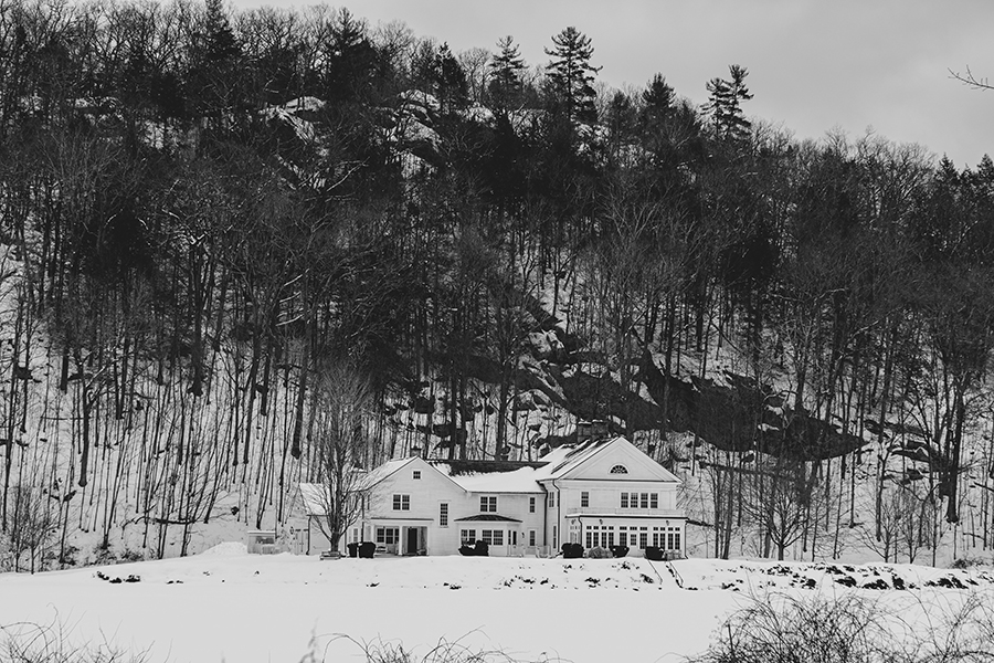 Snow-covered house surrounded by trees in the Upper Peninsula near Marquette, MI