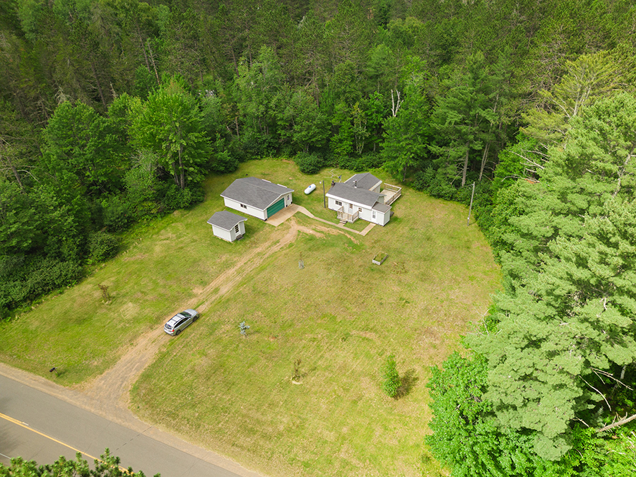Modest 1-bedroom home with oversized two-car garage on nearly 3 wooded acres in Marquette County, Michigan